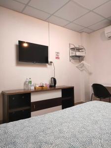 a bedroom with a bed and a tv on the wall at Subsopon in Phra Nakhon Si Ayutthaya +19 photos