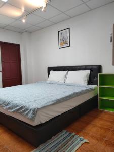 a bedroom with a large bed with a black headboard at Subsopon in Phra Nakhon Si Ayutthaya +19 photos