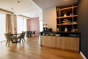 a living room with a table and chairs at Vila Sarisa in Deva