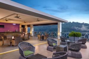 a patio with chairs and tables and a bar at Radisson Hotel Kandy in Kandy