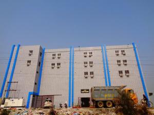 a large building with a dump truck in front of it at Hotel Glory Grand, Rajgir in Rājgīr