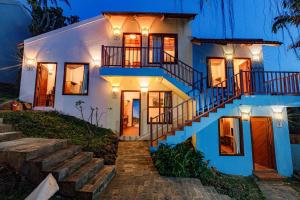 a white house with stairs in front of it at Star Hill Village Resort Phu Quoc in Phu Quoc