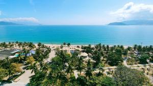 an aerial view of a beach with palm trees and the ocean at The Light Hotel in Nha Trang