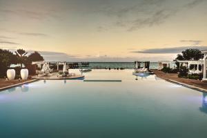 a swimming pool with the ocean in the background at Essque Zalu Zanzibar in Nungwi
