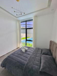 a bedroom with a large bed and a large window at Granada Villas in Jericho