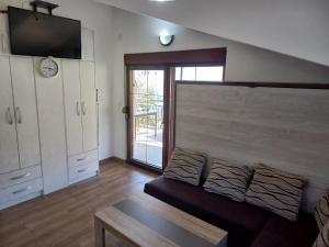 a living room with a couch and a tv in it at Villa Ivan in Risan