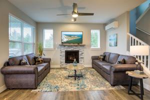 a living room with two couches and a fireplace at The Jetty House in Ocean Shores