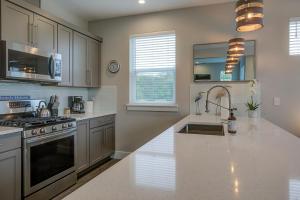 a kitchen with a sink and a stove at The Jetty House in Ocean Shores
