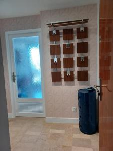 a room with a door and a window and a blue suitcase at Fenestrelle By LGM une chambre, climatisation, wifi in La Grande-Motte +16 photos