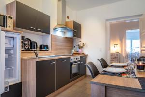 a kitchen with a table and a dining room at komfortable Ferienwohnung in Halle in Halle an der Saale +33 photos