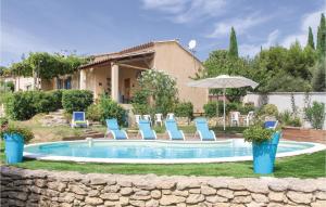 una piscina con sedie e ombrellone in un cortile di 4 Bedroom Beautiful Home In Goult a Goult