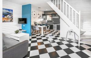 a kitchen and living room with a checkered floor at Stunning Home In Grzybowo With Wifi in Grzybowo
