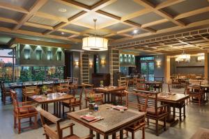 a dining room with wooden tables and chairs at Ela Excellence Resort Belek in Belek