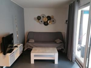 a living room with a couch and a table at VILLA TERRE NEUVE in Signes