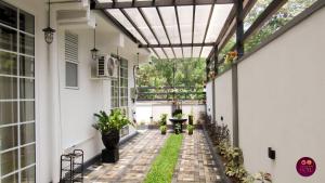 an internal courtyard of a house with a pergola at Airport Faith Hotel in Katunayake
