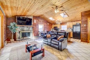a living room with a couch and a fireplace at Pocono Vacation Rental with Game Room! in Tobyhanna