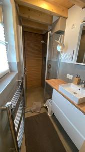 a bathroom with a sink and a toilet and a mirror at Karwendel Chalet in Scharnitz