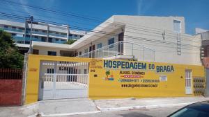 uma casa com um edifício amarelo e branco em Cabo Frio - Braga - Kitnets - Aluguel Econômico em Cabo Frio