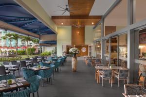 a dining room with tables and chairs and a restaurant at Radisson Blu Resort Galle in Galle