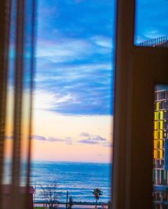 a view of the ocean from a window at Beach House in Batumi