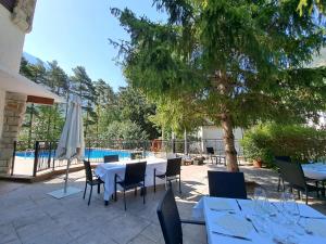 a patio with a table and chairs and a pool at Hotel & Spa Real Villa Anayet in Canfranc-Estación