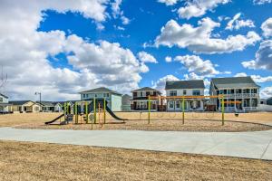a playground with a slide in front of houses at Cozy Montana Retreat with Patio and Fire Pit! in Billings