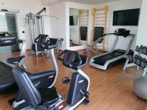 a gym with several treadmills and exercise bikes at Torri Camuzzi Exclusive Luxury Apartment in Pescara