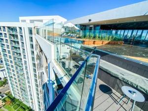 a balcony of a building with a swimming pool at Luxury 1 bedroom apartment in vibrant Menlyn Maine in Pretoria