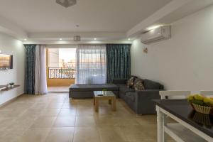 a living room with a couch and a table at Selena Bay Resort & Beach Club in Hurghada