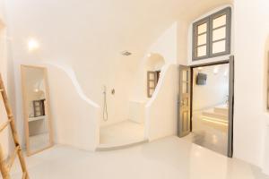 a white bathroom with a staircase leading to a shower at Cilon Suites Santorini in Imerovigli