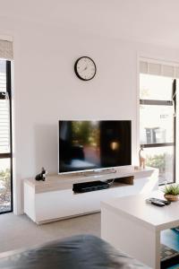 a living room with a large flat screen tv at Nelson Central Town House in Nelson