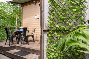a patio with two chairs and a table on it at Richmond Private Rooms - 151 Hoddle Homestay in Melbourne