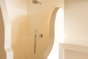 a shower stall in a bathroom with a shower at Cilon Suites Santorini in Imerovigli