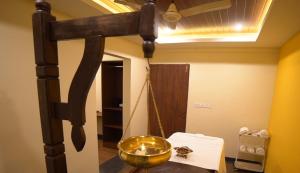 a room with a gold bowl on a swing at Aananda Wellness and Resorts in Dharmastala +37 photos