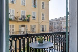 a table with a bowl of fruit on a balcony at JEAN MÉDECIN - Modern Flat - Heart of center in Nice