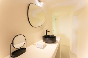 a bathroom with a sink and a mirror on a counter at Cilon Suites Santorini in Imerovigli