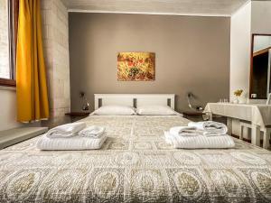 Postel nebo postele na pokoji v ubytování B&B Il Leccio