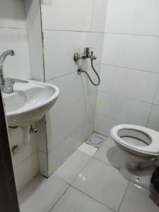 a white bathroom with a sink and a toilet at Nubian King in Aswan