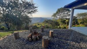 a pile of logs sitting on top of a pile of rocks at Oribi Gorge Villa in Glendale