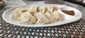 a white plate of dumplings on a table at Mirik Homestay in Mirik