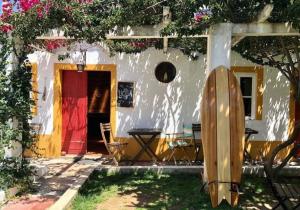 a house with a surfboard in front of it at Olive3 Ericeira in Ericeira