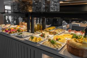 a buffet line with many different types of food at Hotel BUKOVINA in Bukowina Tatrzańska