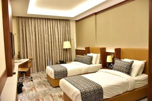 Postel nebo postele na pokoji v ubytování فندق رويال فيستا Royal Vista Hotel