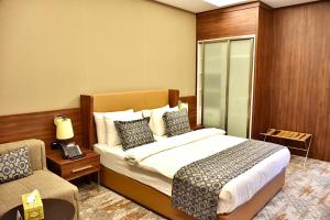 Postel nebo postele na pokoji v ubytování فندق رويال فيستا Royal Vista Hotel