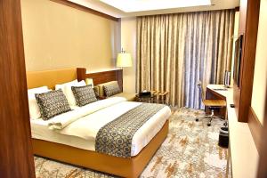 Postel nebo postele na pokoji v ubytování فندق رويال فيستا Royal Vista Hotel