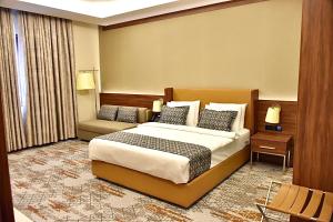 Postel nebo postele na pokoji v ubytování فندق رويال فيستا Royal Vista Hotel