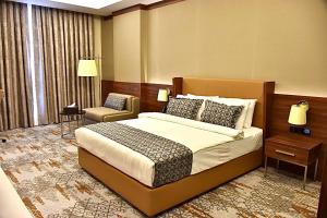 Postel nebo postele na pokoji v ubytování فندق رويال فيستا Royal Vista Hotel