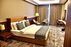 Postel nebo postele na pokoji v ubytování فندق رويال فيستا Royal Vista Hotel