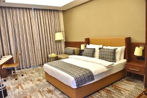 Postel nebo postele na pokoji v ubytování فندق رويال فيستا Royal Vista Hotel