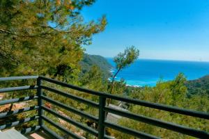 a view of the ocean from a balcony at Tree Houses Hotel in Fethiye